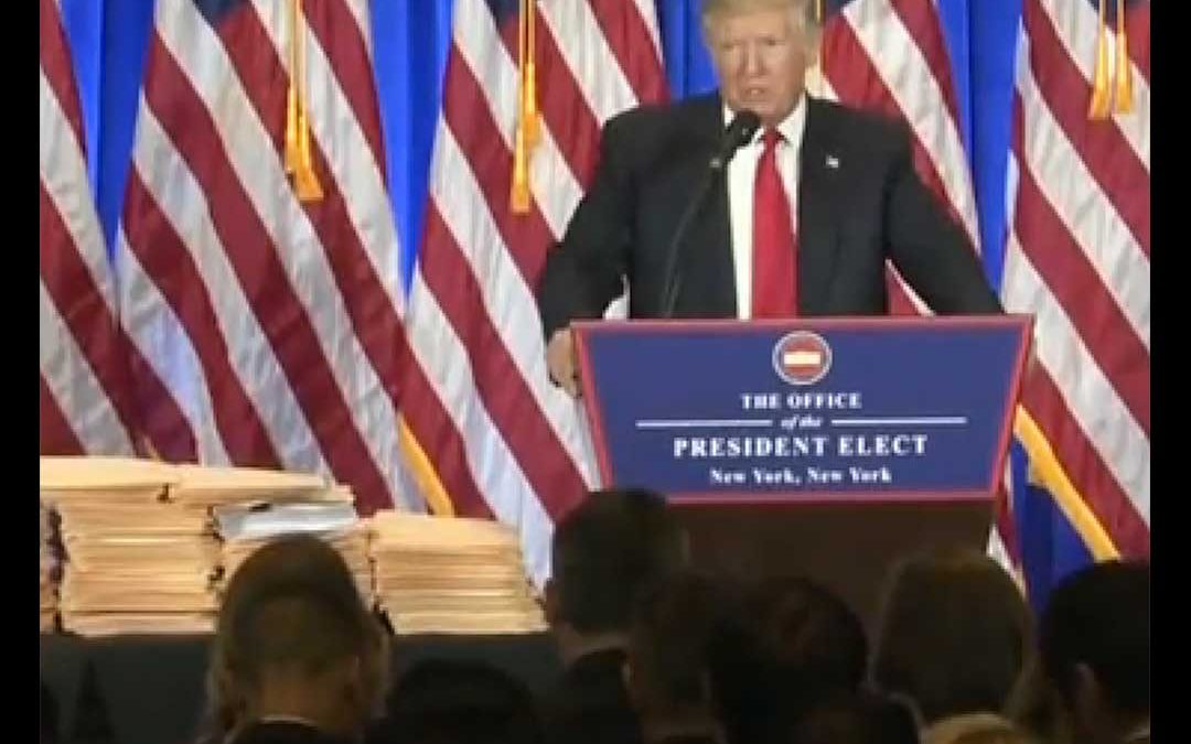 President ELect Trump with a table of documents.