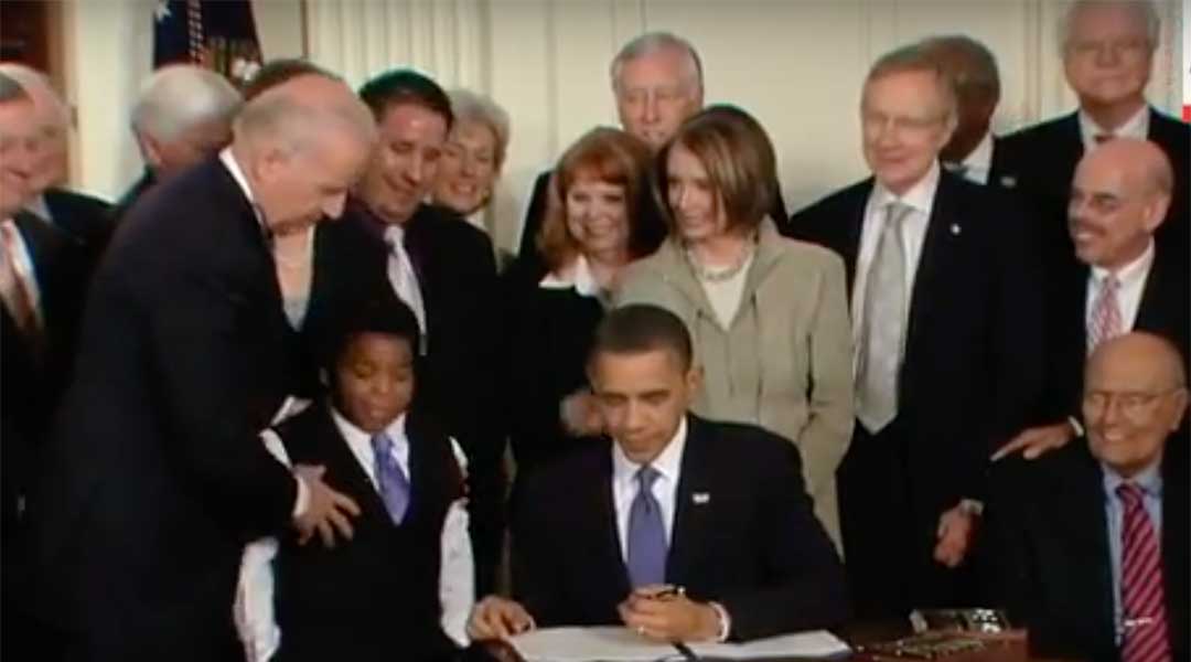 Obama signs the Affordable Care Act.
